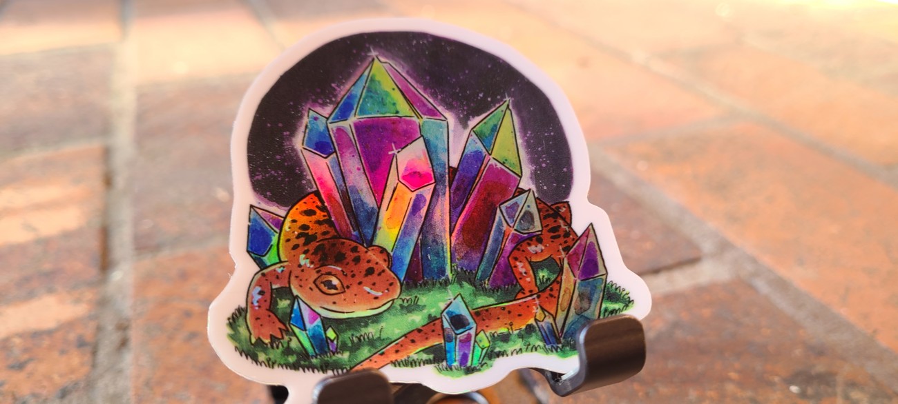 Holographic tiger salamander guarding a cluster of iridescent crystals
