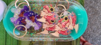 Profile view of a purple curly haired girl with stars in her hair. Eyes are closed. To the left.