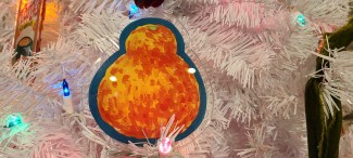 Satsuma acrylic ornament on a white Christmas tree